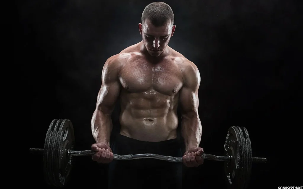 A man engaged in lifting a barbell, highlighting fitness and strength, as discussed in the Winstrol Guide article.
